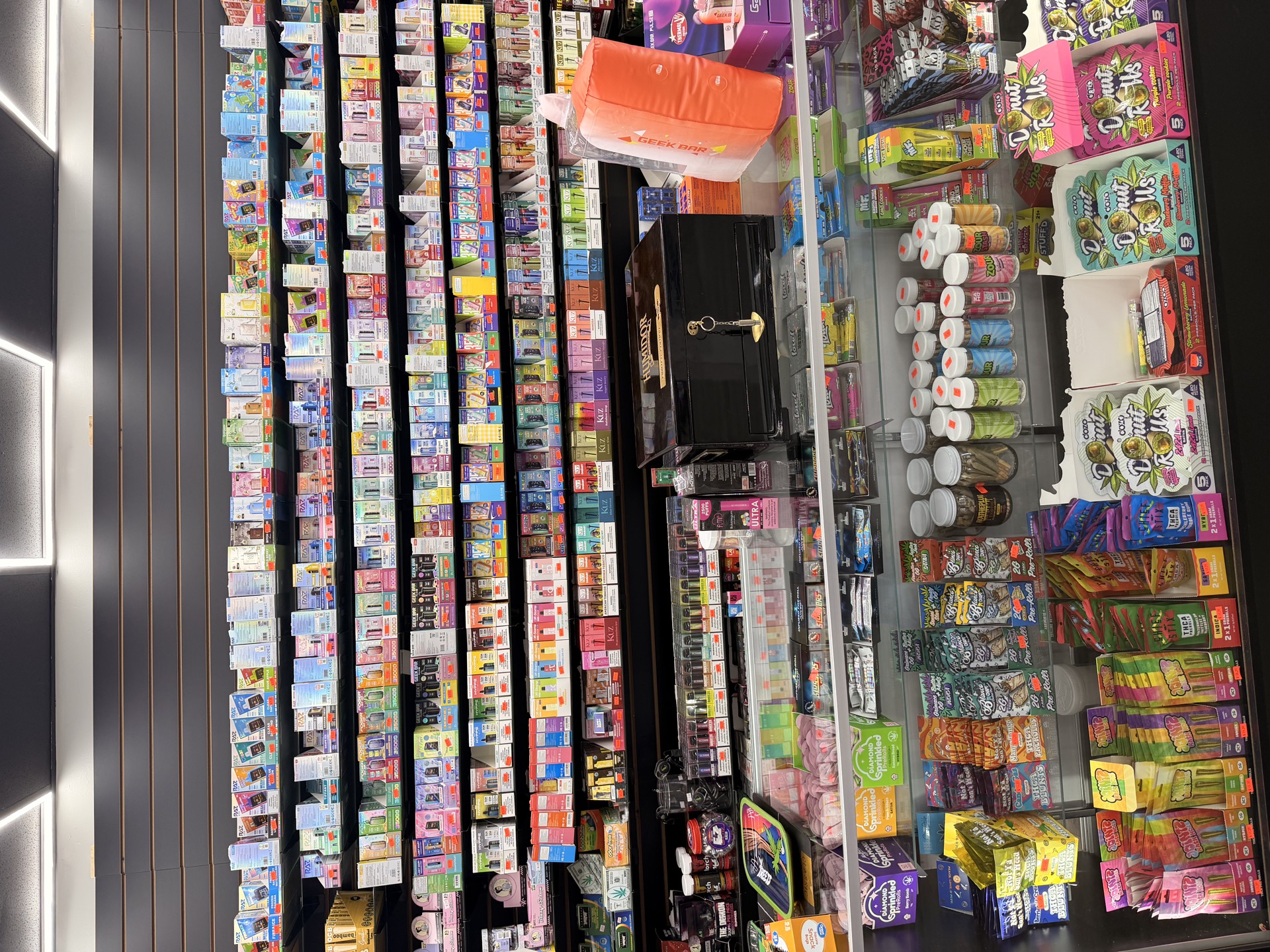 Extensive vape and disposable selection wall at High Mood Smoke Shop